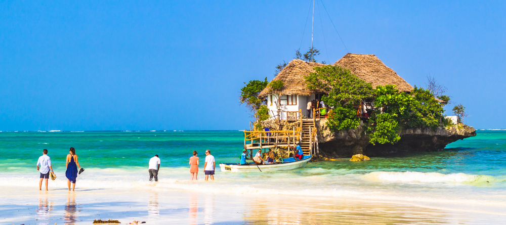 Paje, Zanzibar, Tanzania - January 19, 2018: People waiting for boat to famous restaurant Rock. Paje, Zanzibar, Tanzania.